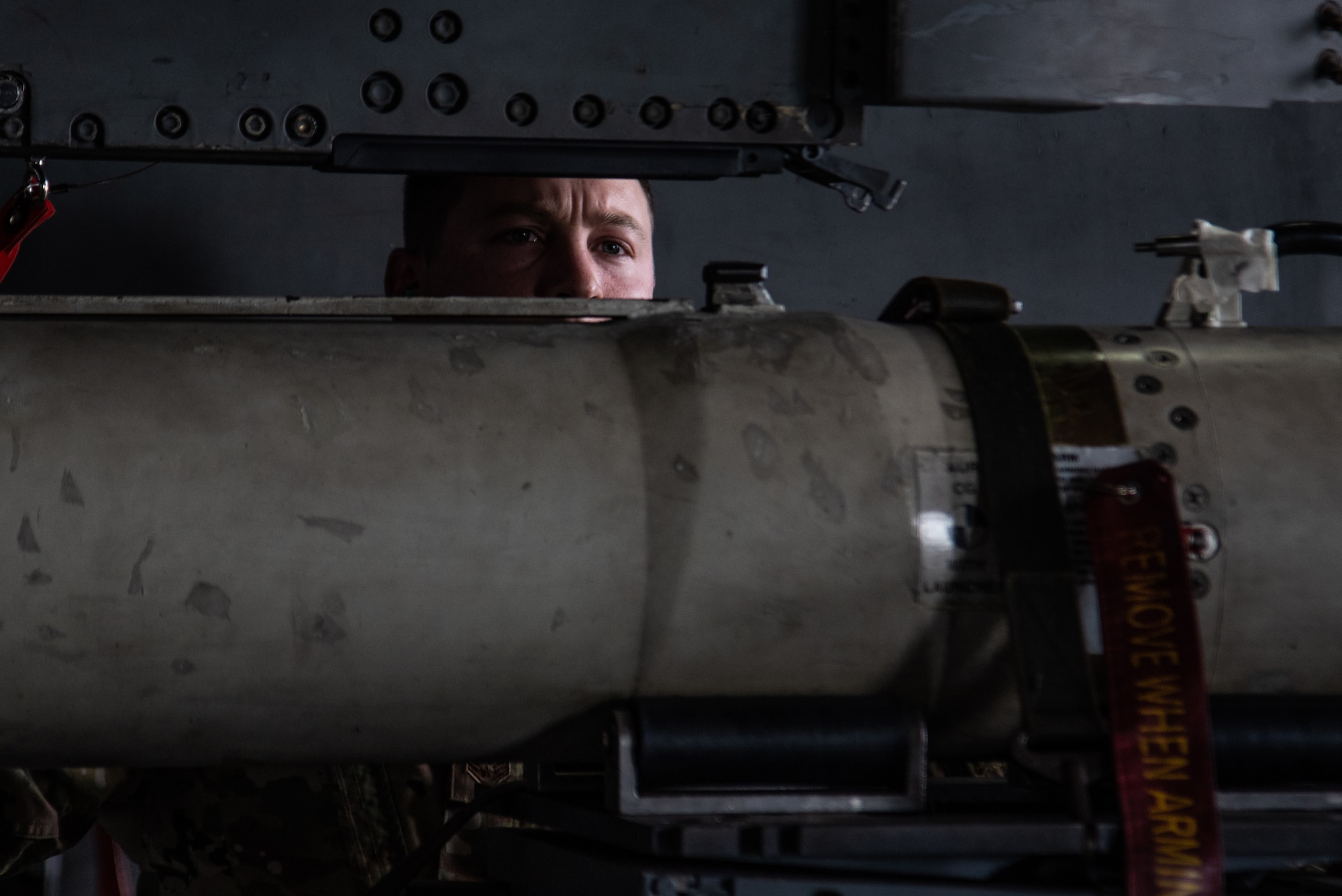 U.S. Air Force Staff Sgt. Justin Tankersley, 20th Maintenance Group weapons lead crew chief, double checks the new tool he created to ensure it is properly secured on a munition at Shaw Air Force Base, S.C., Oct. 16, 2018.