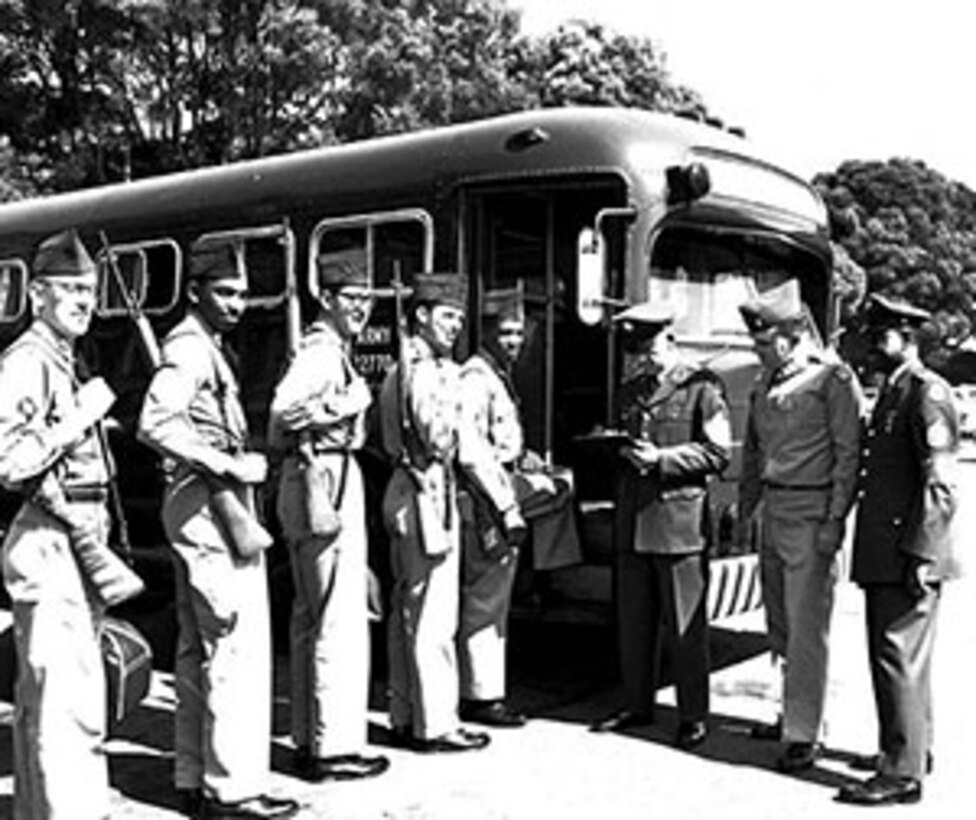 Soldiers from the 16th Infantry load a bus bound for Operation Desert Strike exercises in 1964