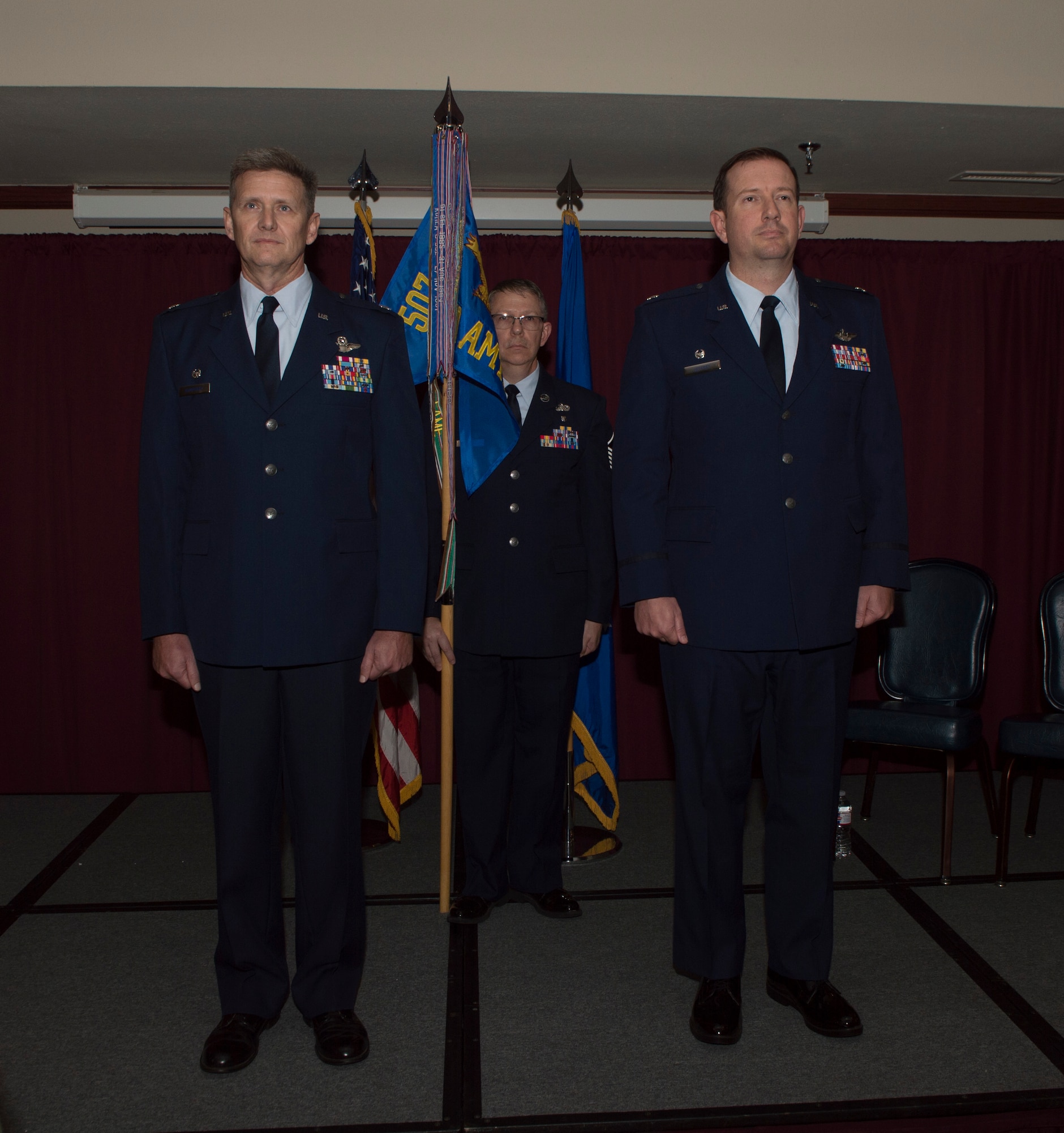 Two men standing in front of a crowd