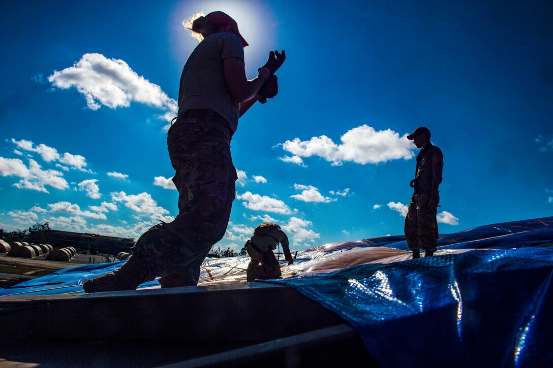 Airmen repair a roof at Tyndall Air Force Base.