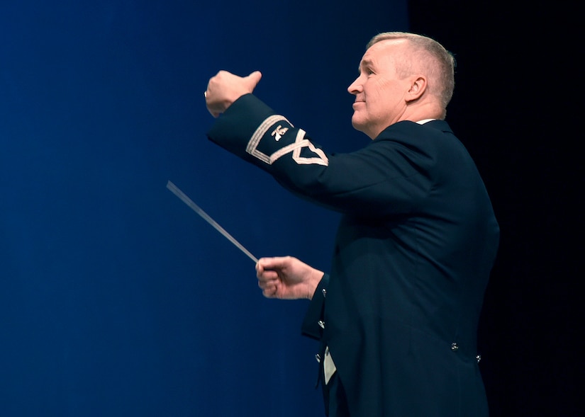 Col. Larry H. Lang, U.S. Air Force Band commander and conductor, leads the band during a performance at Los Alamos High School in Los Alamos, N.M., Oct. 16, 2018. The band aims to inspire patriotism and service as well as honor veterans. (U.S. Air Force photo by Senior Airman Abby L. Richardson)