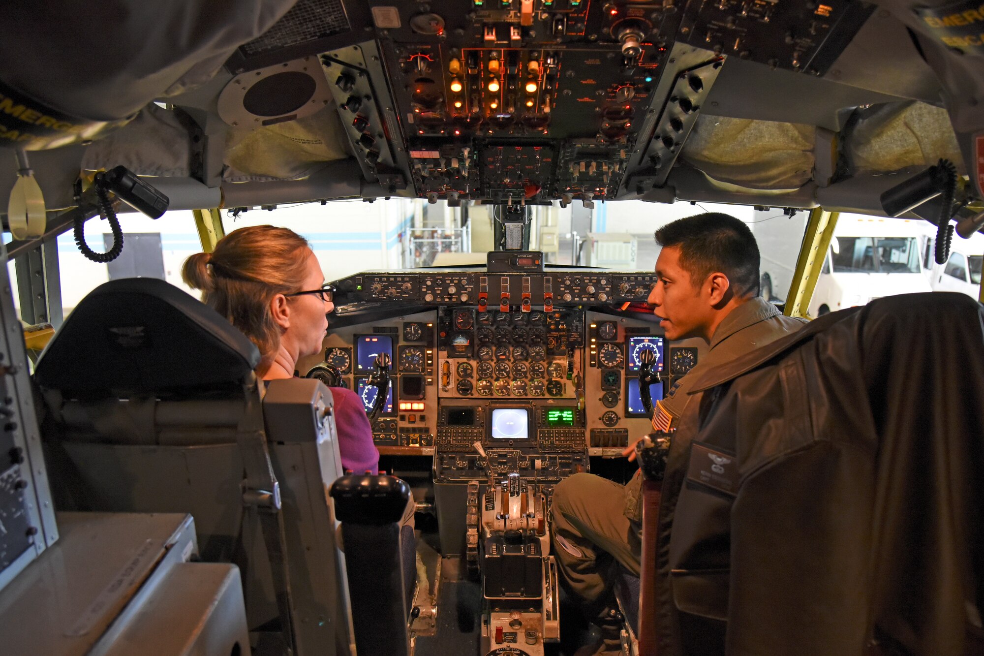 Capt. Kevin Escobedo, 92nd Operations Support Squadron executive officer, speaks with Chief Master Sgt. Mariah Armga, Secretary of the Air Force legislative liaison, about upgrades to the KC-135 Stratotanker during a base tour, Oct. 18, 2018, at Fairchild Air Force Base, Washington. Armga was joined by congressional staffers who represented leaders in Washington D.C. including Georgia Reps. Rick Allen and Sanford Bishop, Washington state Reps. Derek Kilmer and Cathy McMorris Rodgers, and North Carolina Rep. Walter Jones. (U.S. Air Force photo/Staff Sgt. Mackenzie Mendez)