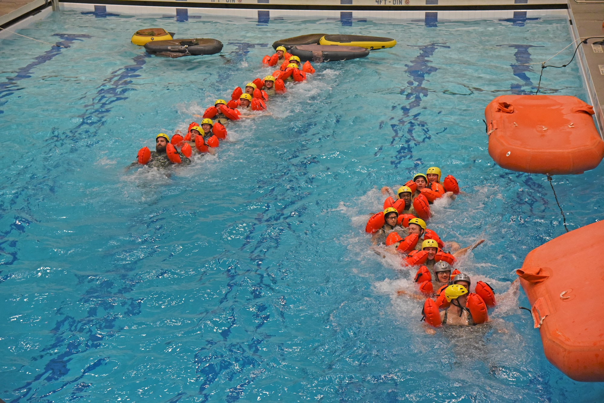 The 336th Training Group Survival, Evasion, Resistance and Escape water survival students practice water survival techniques in case of a water emergency Oct. 18, 2018, at Fairchild Air Force Base, Washington. Congressional staffers watched as SERE instructors demonstrated basic swimming, signaling and jumping techniques for their students. (U.S. Air Force photo/Staff Sgt. Mackenzie Mendez)