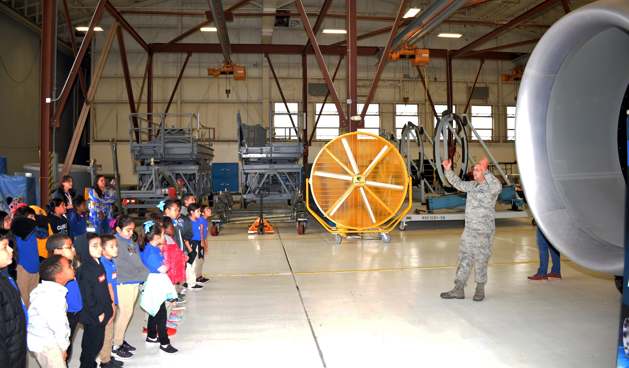 Master Sgt. Sean C. Preston, 433rd Maintenance Squadron propulsion craftsman, describes features and capabilities of a C-5M Super Galaxy engine to third-grade students from Meredith Baskin Elementary at Joint Base San Antonio-Lackland Oct. 19, 2018