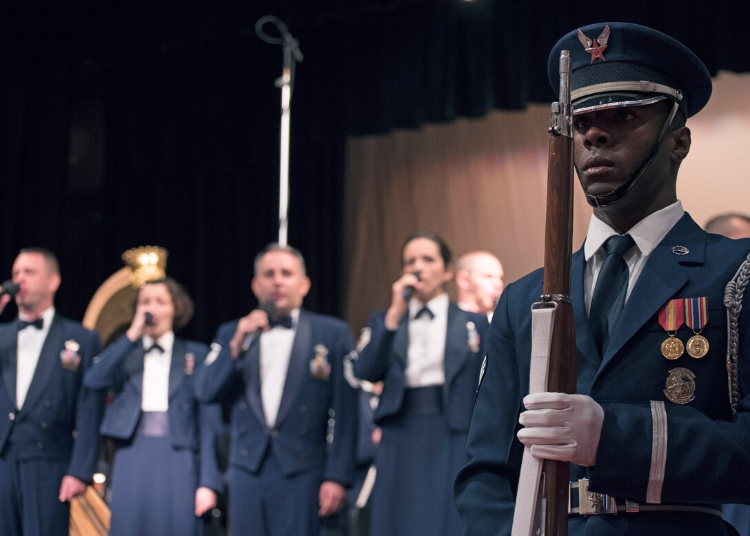 Senior Airman Joron Foster, U.S. Air Force Honor Guard ceremonial guardsman, participates in displaying of the colors before a U.S. Air Force Band performance at the Karen D. Young Memorial Auditorium in Van Horn, Texas, Oct. 20, 2018. Band performances aim to positively impact the community and inspire patriotism. (U.S. Air Force photo by Senior Airman Abby L. Richardson)