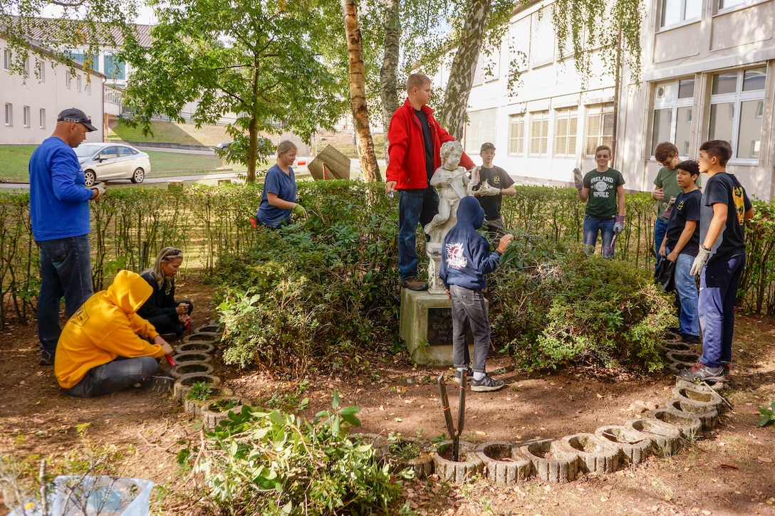Members of Kaiserslautern area Boy Scout Troop 232 work on a student memorial restoration project led by Nathan Perez on October 6, 2018 at what is now Kaiserslautern Middle School.  While this is Perez’s Eagle Scout project, it is meant to honor the memory of Erick Lynch, a Kaiserslautern American High School student and Boy Scout, who was killed in 1998, and to whom this statue was dedicated that year.  Over the years, the memorial had fallen into neglect. (U.S. Army Reserve Photo by Sgt. 1st Class John Freese, 7th MSC Public Affairs)
