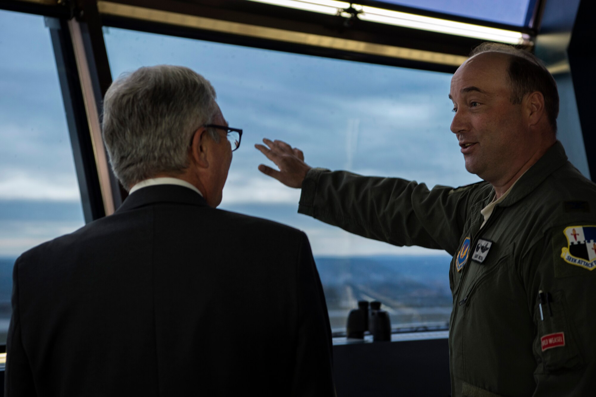 U.S. Air Force Col. Anthony Retka, 52nd Operations Group commander, right, speaks with Roger Lewentz, Minister of the Interior of Rhineland-Palatinate, Germany, left, about aircraft flying schedules in the aircraft control tower at Spangdahlem Air Base, Germany, Oct. 22, 2018. The 52nd Fighter Wing's command team gave Lewentz a base tour to provide him a better understanding of the wing's operations. (U.S. Air Force photo by Airman 1st Class Valerie Seelye)