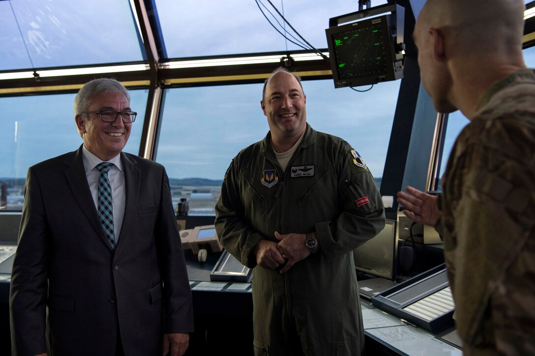 U.S. Air Force Col. Jason Bailey, 52nd Fighter Wing commander, right, and Col. Anthony Retka, 52nd Operations Group commander, center, speak with Roger Lewentz, Minister of the Interior of Rhineland-Palatinate, Germany, left, in the air traffic control tower at Spangdahlem Air Base, Germany, Oct. 22, 2018. Lewentz was provided with a 52nd FW mission brief and visited several locations on base. (U.S. Air Force photo by Airman 1st Class Valerie Seelye)
