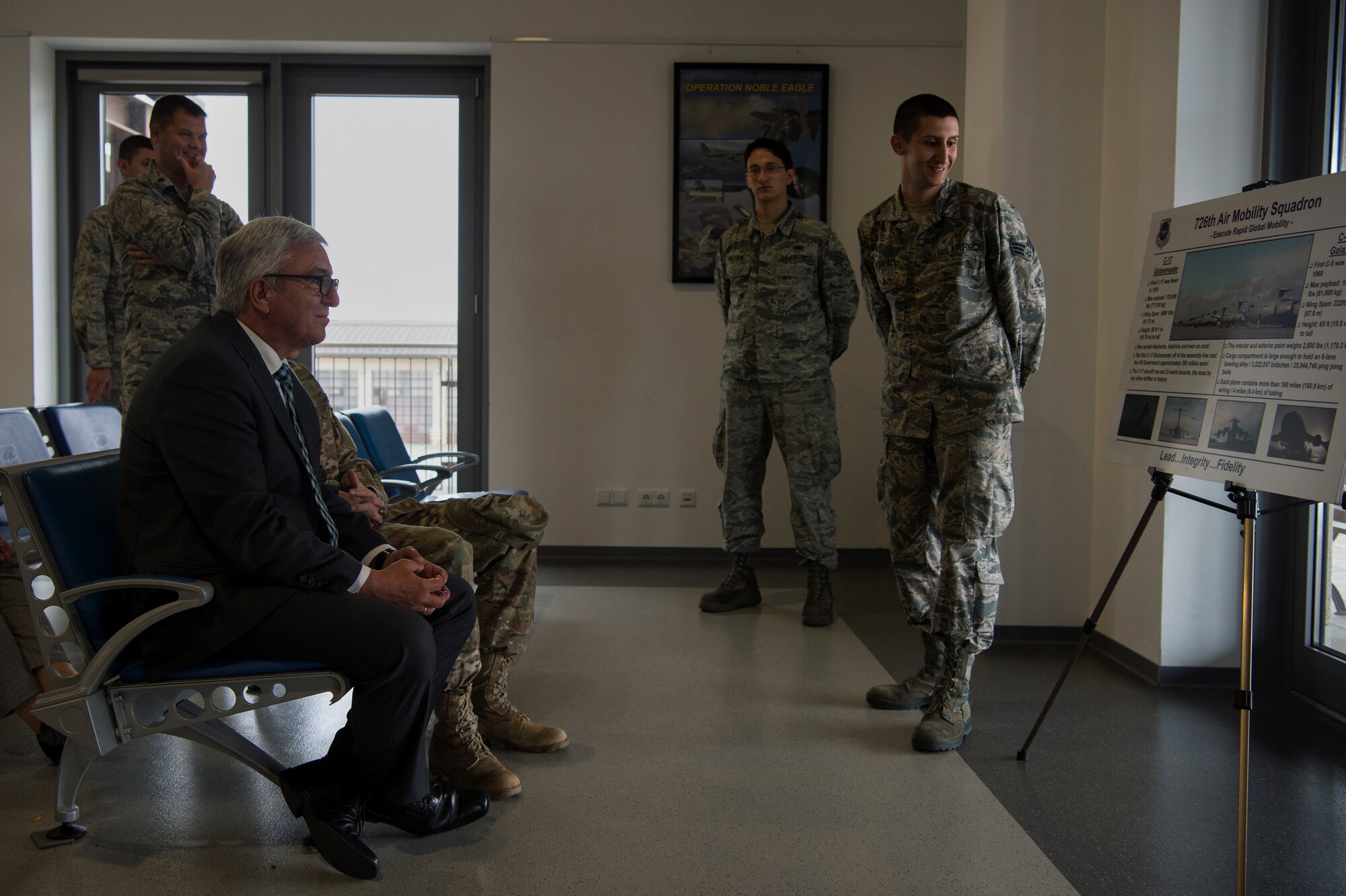 U.S. Air Force Senior Airman Kollin Westfall, 726th Air Mobility Squadron passenger service agent, right, briefs Roger Lewentz, Minister of the Interior of Rhineland-Palatinate, Germany, front left, about the 726th AMS in the passenger terminal at Spangdahlem Air Base, Germany, Oct. 22, 2018. Base visits from members of the local government help strengthen military connections in Europe. (U.S. Air Force photo by Airman 1st Class Valerie Seelye)