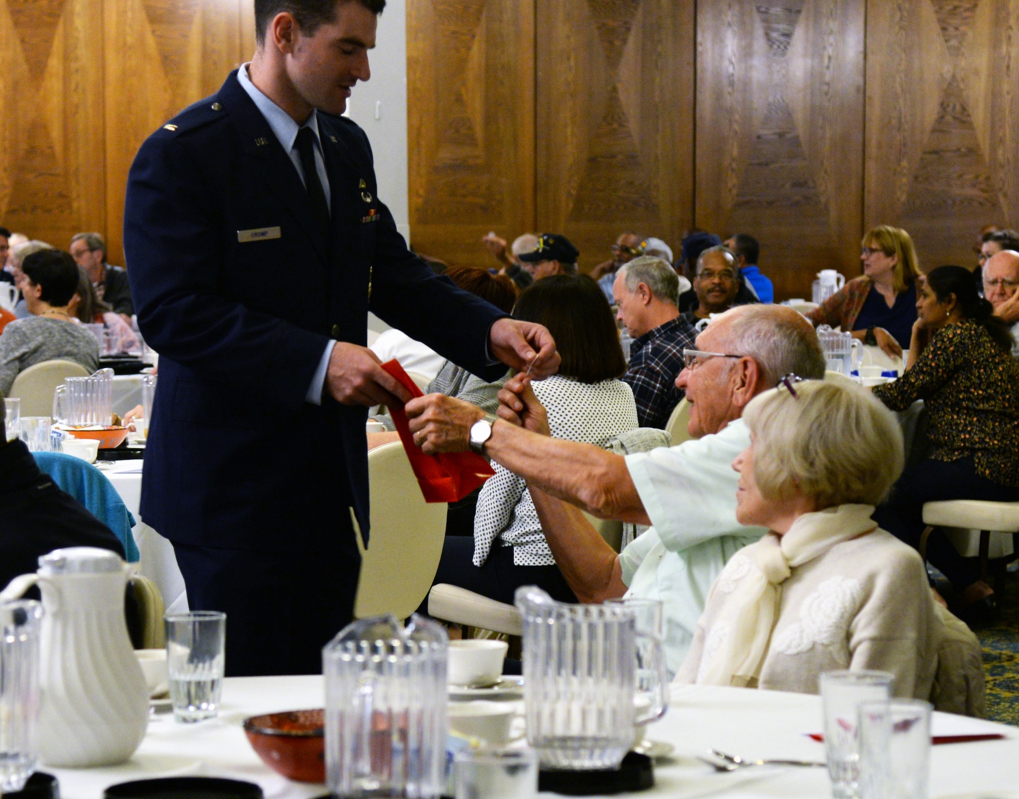 U.S. Air Force 2nd Lt. Stephen Cromp, 569th United States Forces Police Squadron flight commander, gives a prize to a veteran during Retiree Appreciation Day on Ramstein Air Base, Germany, Oct. 18, 2018.