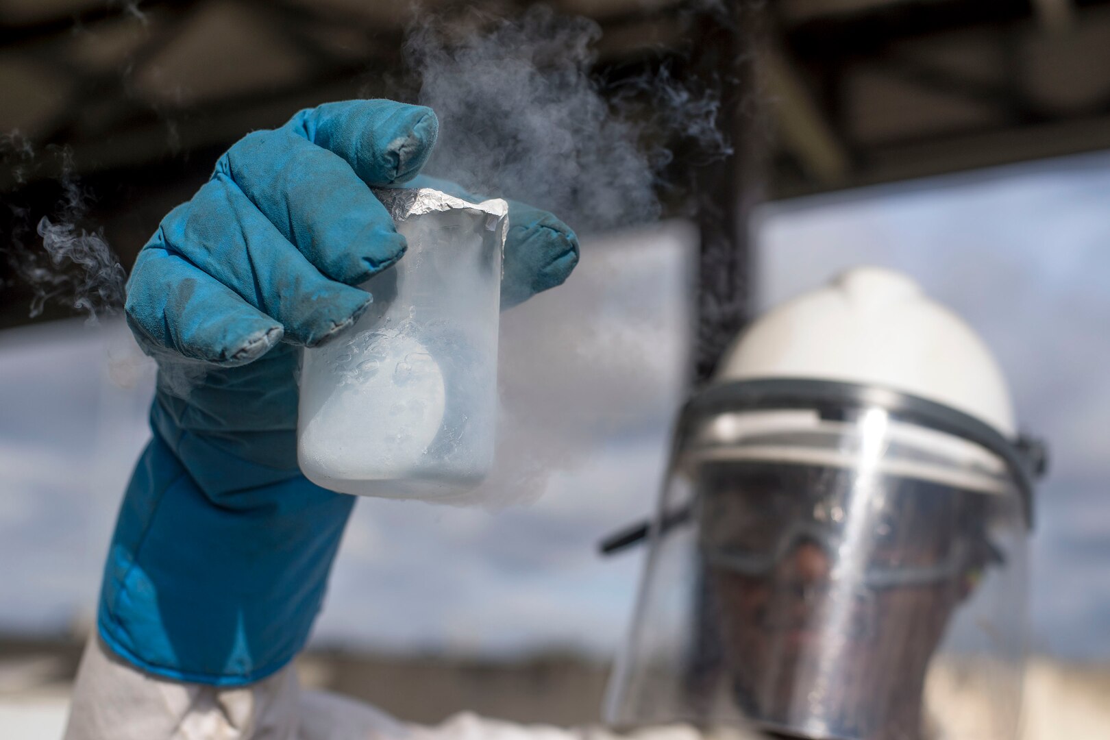 U.S. Air Force Senior Airman Kameron Ware, 100th Logistics Readiness Squadron Fuels Facilities operator, tests 200 milliliters of liquid oxygen at RAF Mildenhall, England, Oct. 2, 2018. Facilities Airmen wear protective equipment while testing liquid oxygen due to the low temperature of - 297 degrees Fahrenheit. (U.S. Air Force photo by Staff Sgt. Christine Groening)