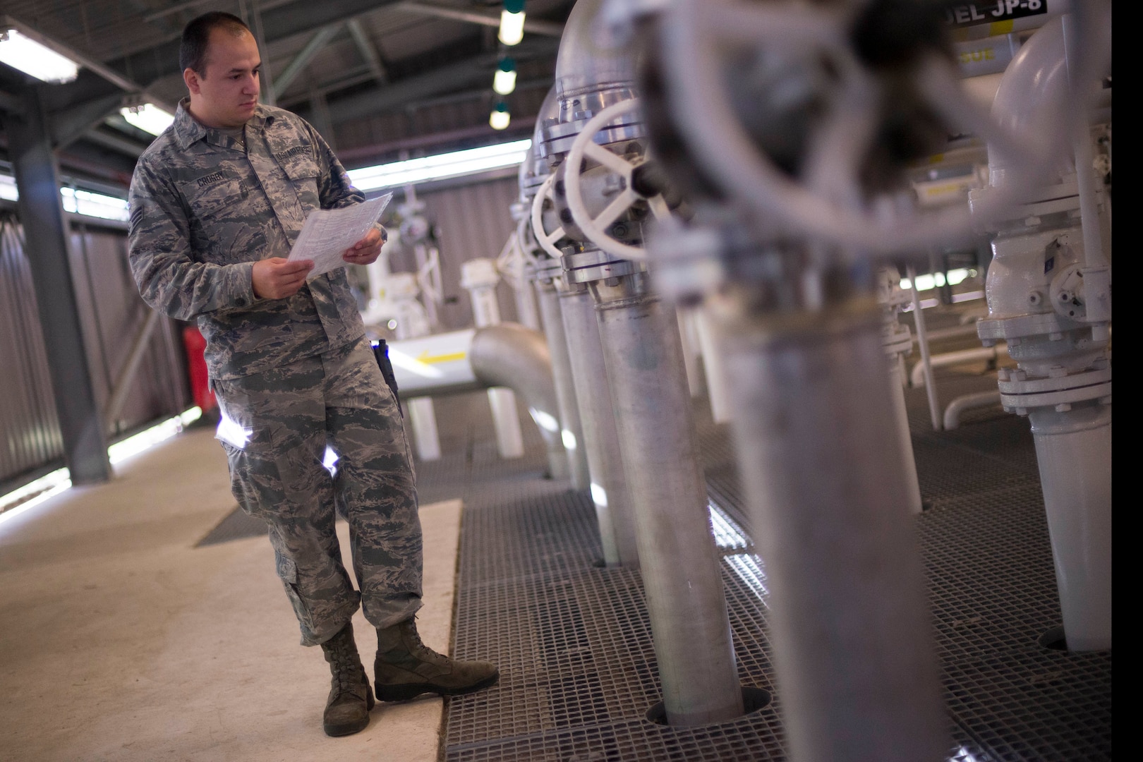U.S. Air Force Senior Airman Christopher Crosby, 100th Logistics Readiness Squadron Fuels Facilities operator, checks system valve configuration at RAF Mildenhall, England, Oct. 9, 2018. Fuels facilities Airmen complete daily, weekly and monthly checks to fuels facilities and equipment. (U.S. Air Force photo by Staff Sgt. Christine Groening)