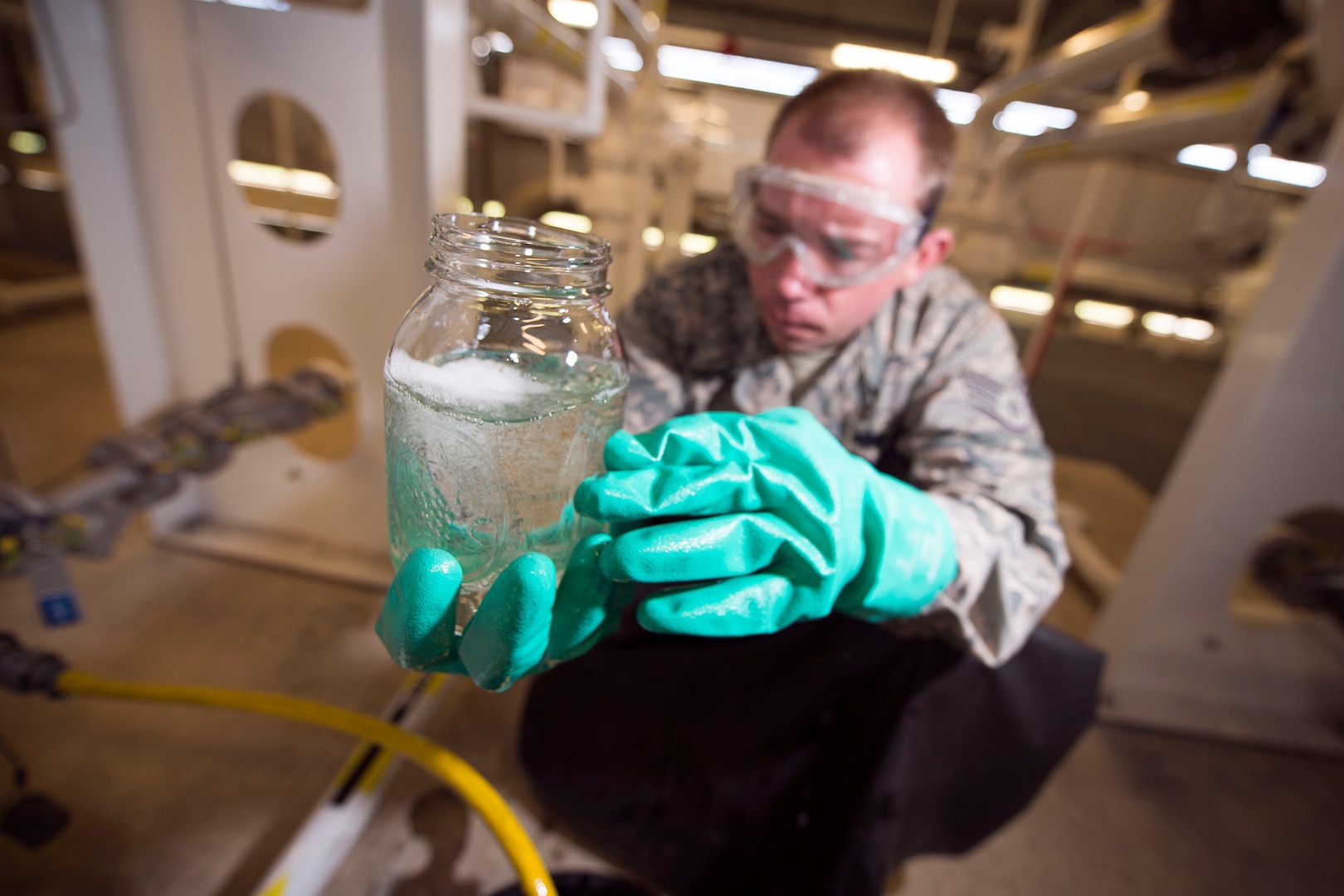 U.S. Air Force Staff Sgt. Charles Arndt, 100th Logistics Readiness Squadron Fuels Facilities supervisor, checks the quality of a fuel sample at RAF Mildenhall, England, Oct. 9, 2018. When checking fuel samples, fuels facilities Airmen check for sediments or water contamination. (U.S. Air Force photo by Staff Sgt. Christine Groening)