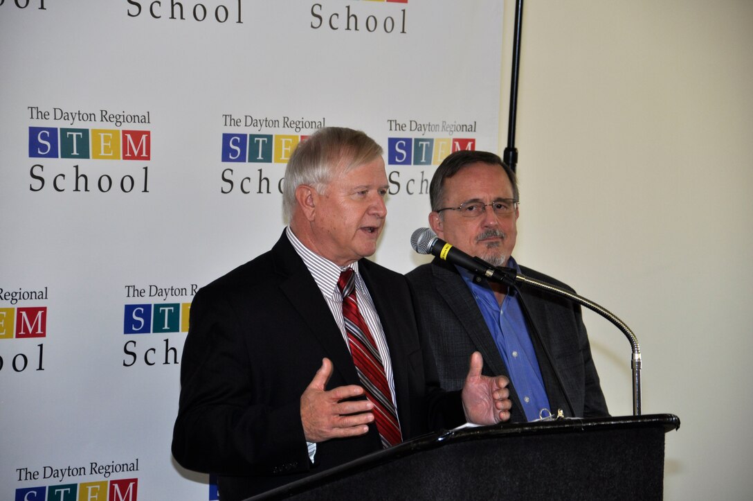 Jack Blackhurst, executive director of the Air Force Research Laboratory, and Dr. Winston “Wink” Bennett Jr., technical advisor, 711th Human Peformane Wing Warfighter Readiness Research Division, deliver remarks about AFRL’s Gaming Research Integration for Learning Laboratory, or GRILL®, during a “Brick Breaking” ceremony Oct. 19 at the Dayton Regional STEM School facility on Woodman Road in Kettering, Ohio, to kick off a $2 million capital project. The GRILL® will be moving into the new facility upon completion of the renovation project in March 2019. (U.S. Air Force photo/Bryan Ripple)