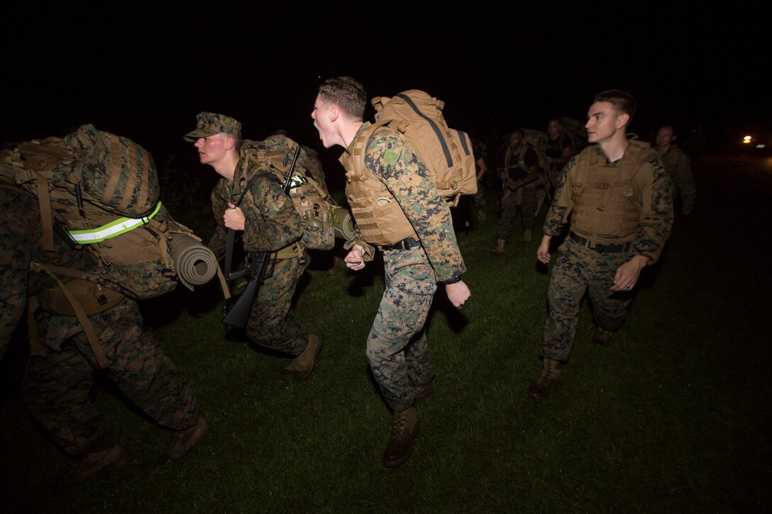 Sgt. Xavier S. Ham, a motor transport dispatcher with S-4, Headquarters Battalion, Marine Forces Reserve, yells at a Naval Reserve Officers Training Corps Midshipmen from Tulane University to keep up during a 10 kilometer hike around an Armed Forces Reserve Center in Baton Rouge, La., October 20, 2018. Marines from Marine Forces Reserve, in New Orleans, assisted in the hike to provide personal experiences and motivation for midshipman to better prepare them for Officer Candidate School and for their future military careers. (U.S. Marine Corps photo by Cpl. Niles Lee)