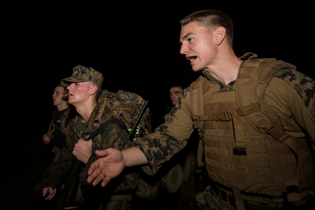 Sgt. Justin A. Sullenger, a motor transport dispatcher with S-4, Headquarters Battalion, Marine Forces Reserve, encourages a Naval Reserve Officers Training Corps Midshipmen from Tulane University to keep up during a 10 kilometer hike around an Armed Forces Reserve Center in Baton Rouge, La., October 20, 2018. Marines from Marine Forces Reserve, in New Orleans, assisted in the hike to provide personal experiences and motivation for midshipman to better prepare them for Officer Candidate School and for their future military careers. (U.S. Marine Corps photo by Cpl. Niles Lee)