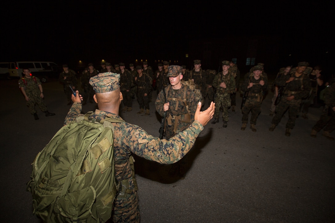 Gunnery Sgt. Alonzo Williams, assistant marine officer instructor with Southern University, talks to Naval Reserve Officers Training Corps Midshipmen from Tulane University, Southern University and Platoon Leadership Course, after a 10 kilometer hike around an Armed Forces Reserve Center in Baton Rouge, La., October 20, 2018. Marines from Marine Forces Reserve, in New Orleans, assisted in the hike to provide personal experiences and motivation for midshipman to better prepare them for Officer Candidate School and for their future military careers. (U.S. Marine Corps photo by Cpl. Niles Lee)