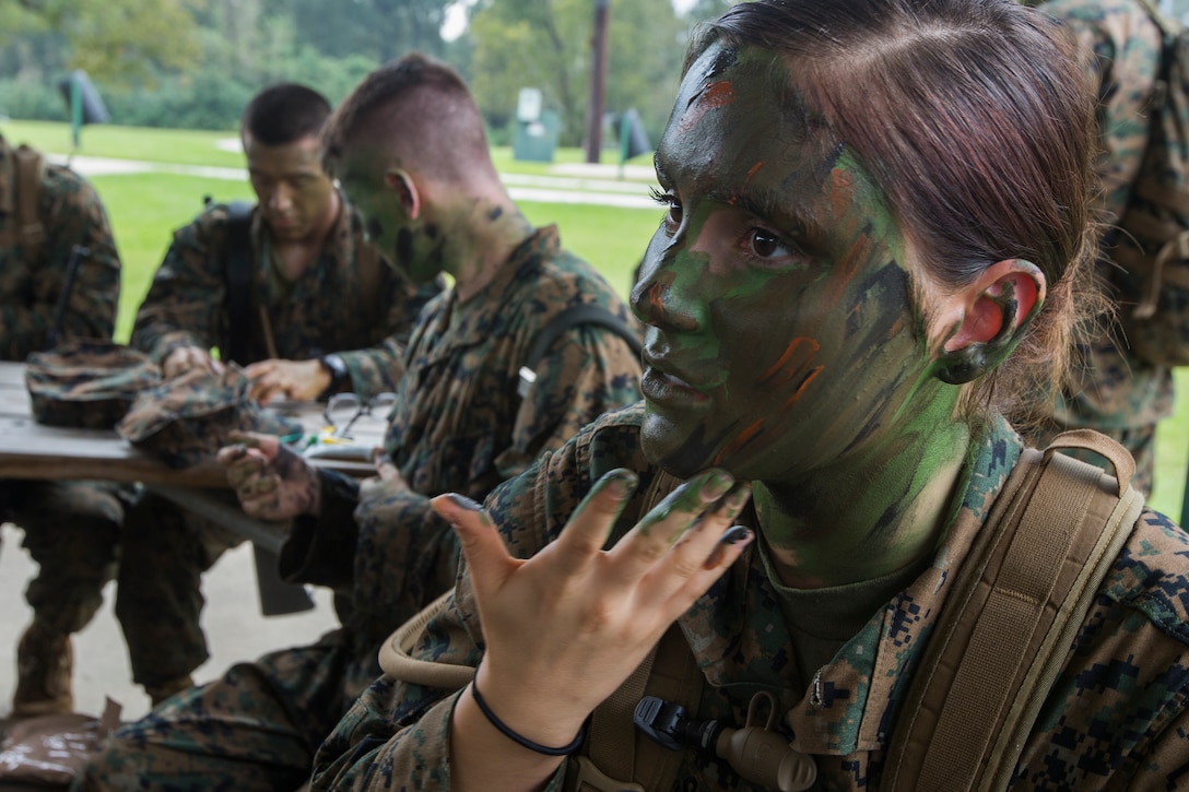 A Naval Reserve Officers Training Corps Midshipmen from Tulane University, applies camouflage paint before small unit leadership evaluations at Hopper Park, in Baton Rouge, La., October 20, 2018. Marines from Marine Forces Reserve, in New Orleans, assisted in the SULEs to provide experience and insight for midshipman to better prepare them for Officer Candidate School and for their future military careers. (U.S. Marine Corps photo by Cpl. Niles Lee)