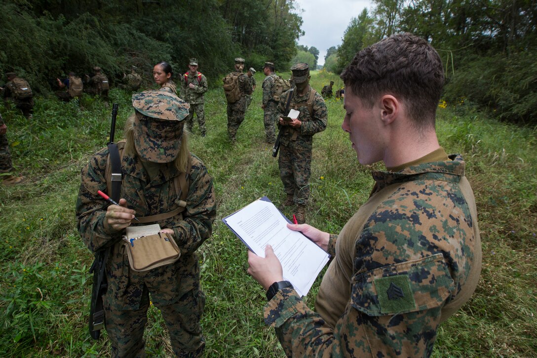 Sgt. Xavier S. Ham, a motor transport dispatcher with S-4, Headquarters Battalion, Marine Forces Reserve, reads a situation to a Naval Reserve Officers Training Corps Midshipmen from Tulane University, during small unit leadership evaluations at Hopper Park, in Baton Rouge, La., October 20, 2018. Marines from MARFORRES, in New Orleans, assisted in the SULEs to provide experience and insight for midshipman to better prepare them for Officer Candidate School and for their future military careers. (U.S. Marine Corps photo by Cpl. Niles Lee)