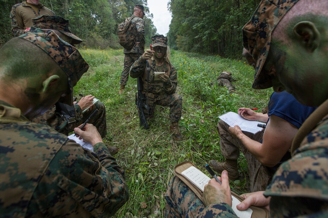 A Naval Reserve Officers Training Corps Midshipmen from Tulane University, briefs her squad leaders during small unit leadership evaluations at Hopper Park, in Baton Rouge, La., October 20, 2018. Marines from Marine Forces Reserve, in New Orleans, assisted in the SULEs to provide experience and insight for midshipman to better prepare them for Officer Candidate School and for their future military careers. (U.S. Marine Corps photo by Cpl. Niles Lee)