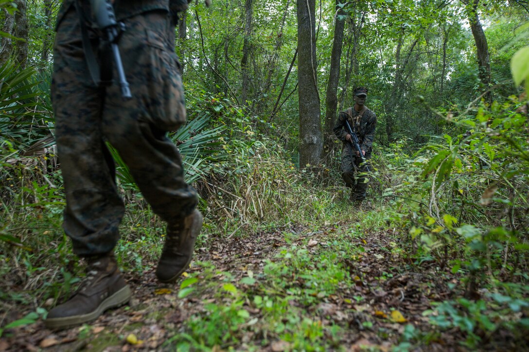 Naval Reserve Officers Training Corps Midshipmen from Tulane University, Southern University and Platoon Leadership Course, patrol a path during small unit leadership evaluations at Hopper Park, in Baton Rouge, La., October 20, 2018. Marines from Marine Forces Reserve, in New Orleans, assisted in the SULEs to provide experience and insight for midshipman to better prepare them for Officer Candidate School and for their future military careers. (U.S. Marine Corps photo by Cpl. Niles Lee)
