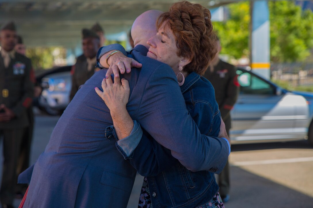 Marine veteran Matthew R. Follett (right) is congratulated by his mother, Betty Roy (left), after he was presented with a Purple Heart in Pasadena, Calif. on October 19, 2018. SSgt Follett received the award for injuries sustained while serving as an active duty counter intelligence specialist with 3rd Battalion, 4th Marine Regiment, 1st Marine Division, on January 7, 2010. (U.S.  Marine Corps photo by Lance Cpl. Samantha Schwoch/released)