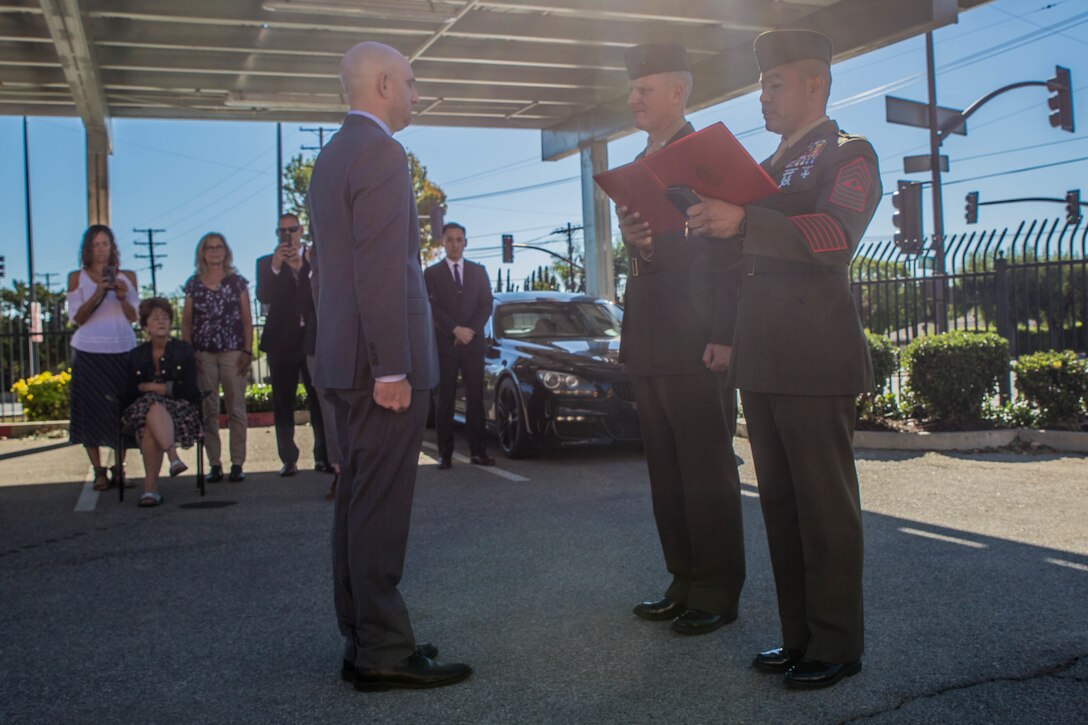 Marine veteran Matthew R. Follett (left), is presented with the Purple Heart by Col. Justin J. Anderson, battalion Inspector Instructor for 2nd Battalion, 23rd Marine Regiment, 4th Marine Division (center) and Sgt. Maj. Israel Rivera, battalion sergeant major of 2nd Bn., 23rd Marines, 4th MarDiv (right) in Pasadena, Calif. on October 19, 2018. SSgt Follett received the award for injuries sustained while serving as an active duty counter intelligence specialist with 3rd Battalion, 4th Marine Regiment, 1st Marine Division, on January 7, 2010. (U.S.  Marine Corps photo by Lance Cpl. Samantha Schwoch/released)