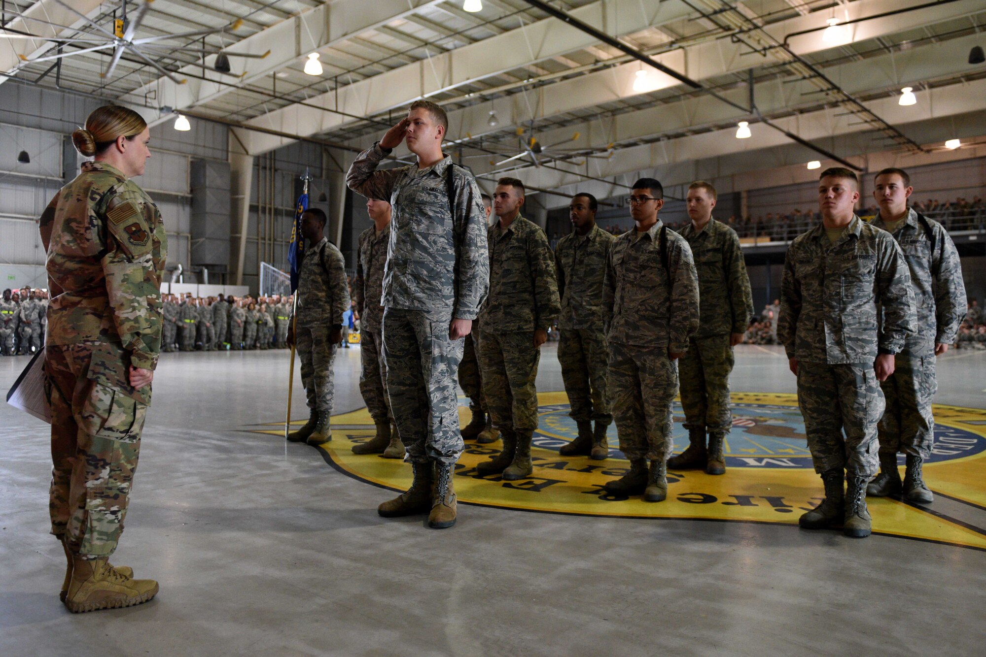Airmen from the 312th Training Squadron salute a judge before starting their regulation drill during the quarterly drill competition at the Louis F. Garland Department of Defense Fire Academy on Goodfellow Air Force Base, Texas, Oct. 19, 2018. Each squadron performed regulation drill, marching through a standard set of maneuvers. (U.S. Air Force photo by Senior Airman Randall Moose/Released)