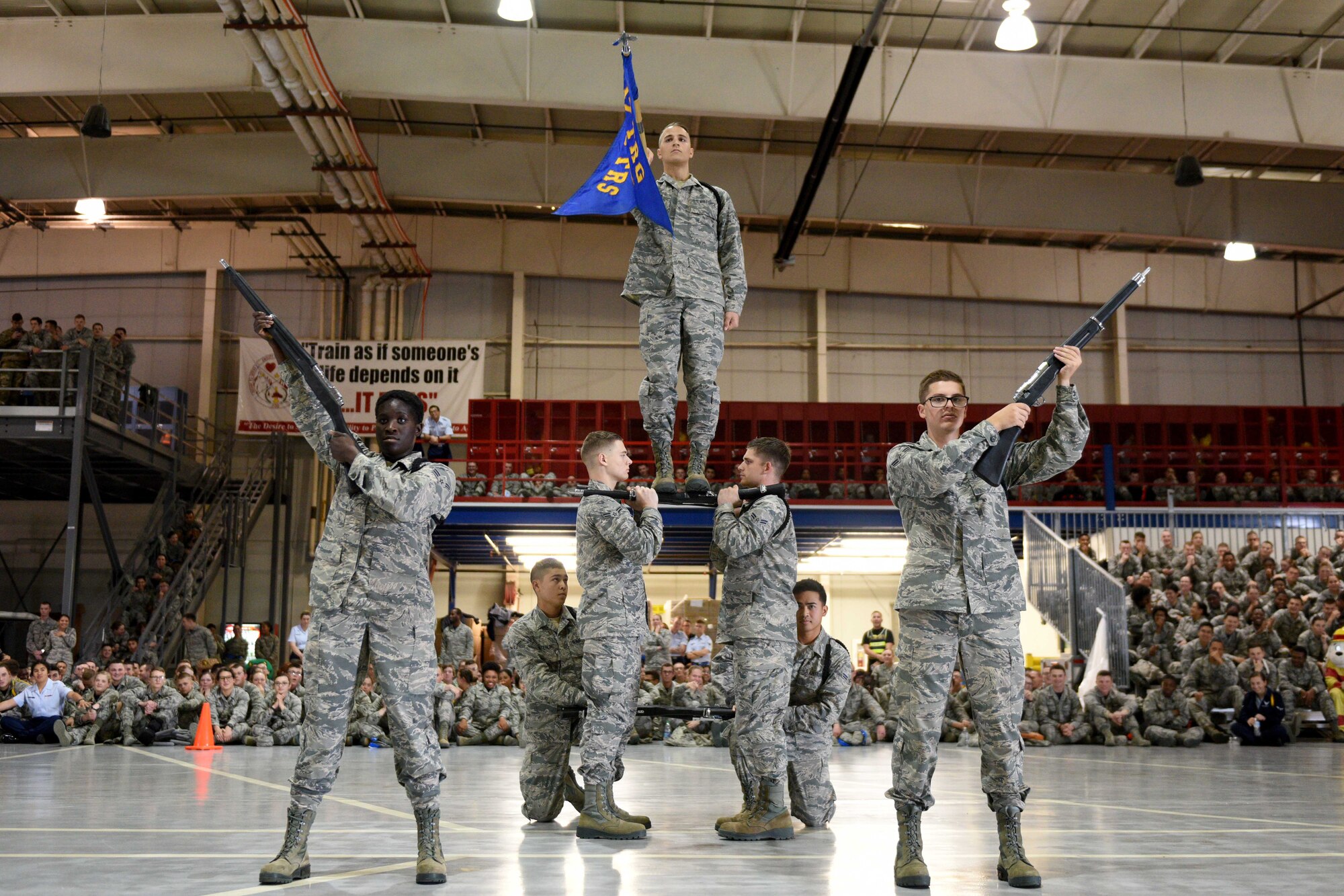 Airmen from the 316th Training Squadron perform an exhibition drill during the quarterly drill competition at the Louis F. Garland Department of Defense Fire Academy on Goodfellow Air Force Base, Texas, Oct. 19, 2018. Competitors performed creative salutes to finish their exhibition drills.  (U.S. Air Force photo by Senior Airman Randall Moose/Released)