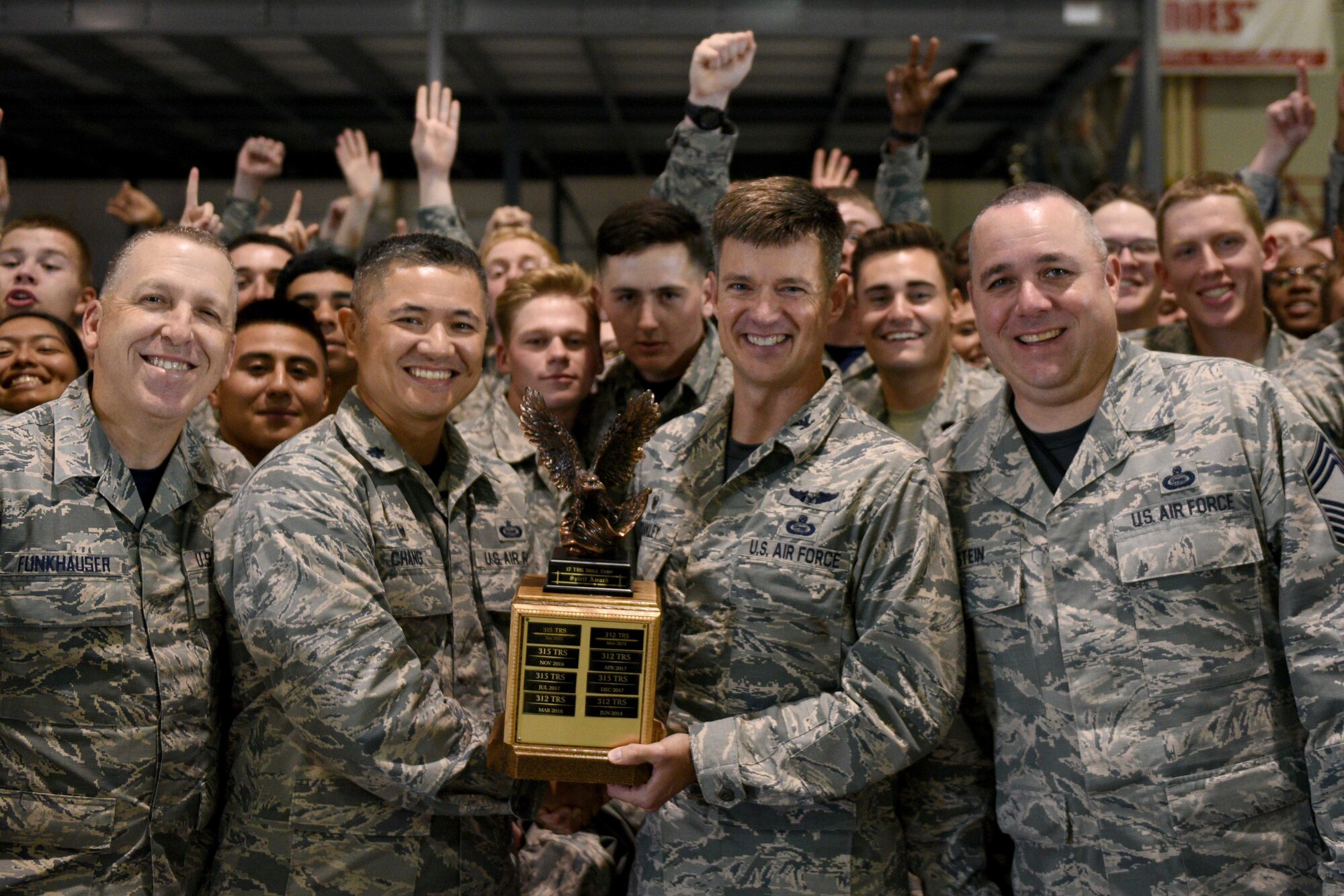 U.S. Air Force Chief Master Sgt. Jason Funkhauser 315th Training Squadron chief enlisted manager, and Lt. Col. Mark Chang, 315th TRS commander, receive the quarterly drill competition trophy from Col. Thomas Coakley, 17th Training Group commander, and Chief Master Sgt. Daniel Stein, 17th TRG superintendent, at the Louis F. Garland Department of Defense Fire Academy on Goodfellow Air Force Base, Texas, Oct. 19, 2018. The winning group will be performing at Lackland AFB, San Antonio. (U.S. Air Force photo by Senior Airman Randall Moose/Released)