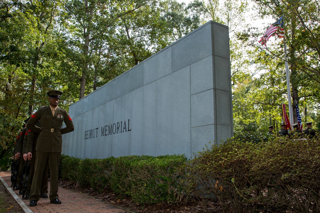 U.S. Marines stand at parade rest in front of the Beirut Memorial  in Lejeune Memorial Gardens, Jacksonville, N.C.
