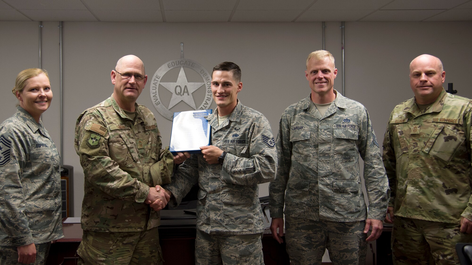 Staff Sgt. Corey S. Radel, 49th Maintenance Group Quality Assurance inspector, was awarded a Chief's Choice Award by Chief Master Sgt. Eric Corvin, 49th Maintenance Group Quality Assurance chief Oct. 19 at Holloman Air Force Base, N.M. (U.S. Air Force photo by Airman 1st Class Kindra Stewart)