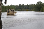 Texas National Guardsmen support vehicles approach a flooded roadway near Huntsville, Texas, Oct. 18, 2018.  Texas Guardsmen worked alongside emergency first responders to help Texans in need during severe flooding.