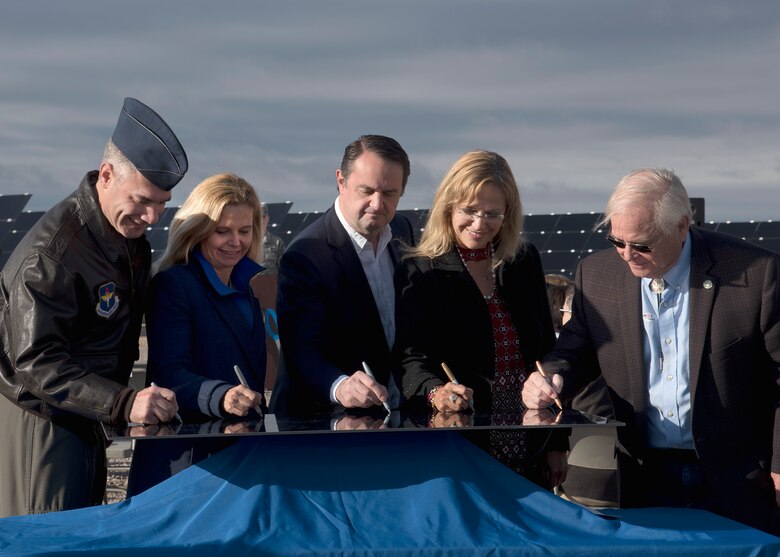 Col. Joseph L. Campo (left), 49th Wing commander, signs a solar panel with the leaders of El Paso Electric, prior to the solar array opening ceremony and ribbon cutting Oct. 19 on Holloman Air Force Base, N.M. The solar array is the product of 5-years of teamwork between EPE, the Air Force Civil Engineer Center and Holloman. (U.S. Air Force photo by Airman 1st Class Kindra Stewart)