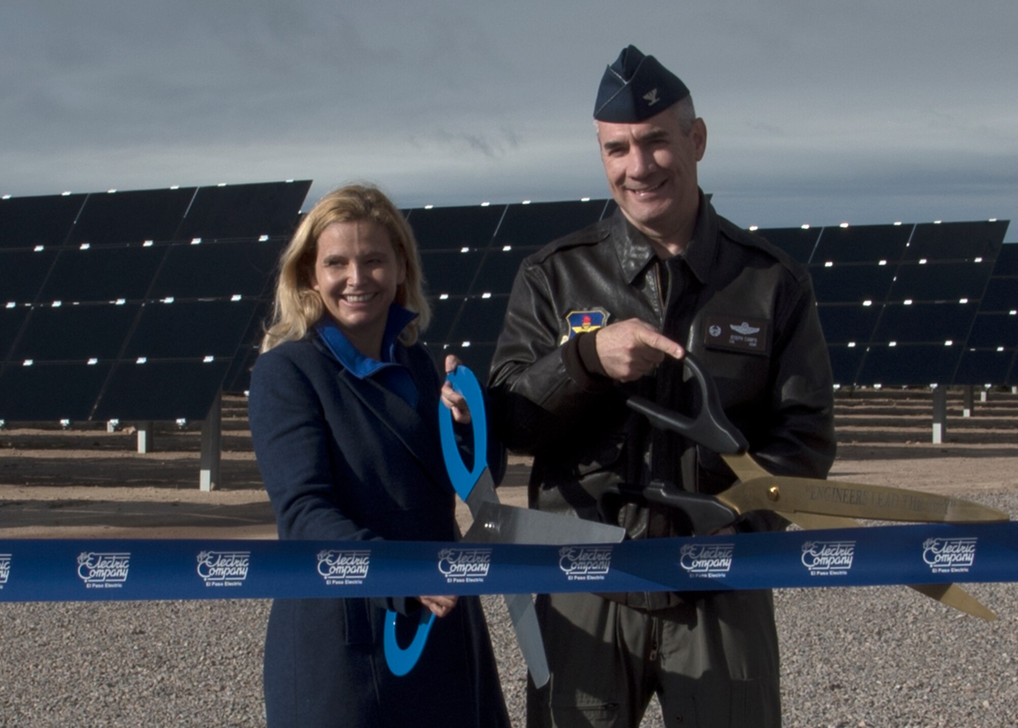 Col. Joseph L. Campo (right), 49th Wing commander, and Mary Kipp (left), El Paso Electric CEO, cut a ribbon at the solar array opening ceremony Oct. 19 on Holloman Air Force Base, N.M. The solar array is made up of almost 56,000 thin-film modules that will generate enough electricity to power more than 1,700 homes annually, prevent emissions by over 9,000 metric tons and save approximately nine million gallons of water. (U.S. Air Force photo by Airman 1st Class Kindra Stewart)