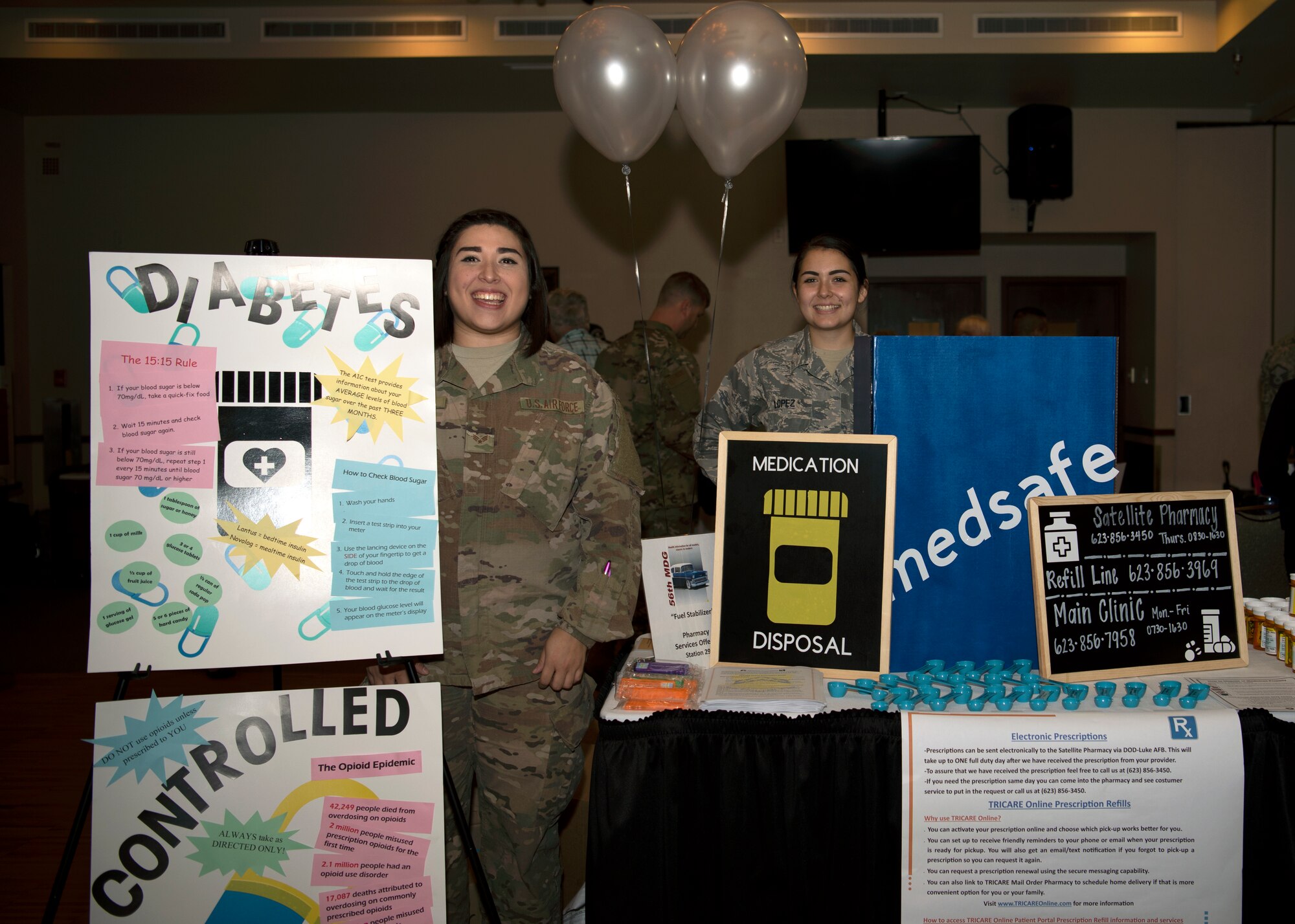 Airmen assigned to the 56th Medical Group stand by their booth at the “Tune up for Health” health fair and car show, Oct. 19, 2018 at Luke Air Force Base, Ariz.
