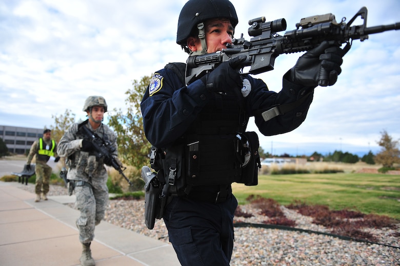 Joshua Nieves, 50th Security Forces Squadron patrolman and Staff Sgt. Xavier Marrero, 50th Security Forces Squadron patrolman, are first on scene in response to an exercise senario for Opinicus Vista 18-2 in the fitness center, at Schriever Air Force Base, Colorado, Oct. 17, 2018.  The 50th Space Wing Inspector General office to assessed emergency services agencies' response to critical incidents. (U.S. Air Force Photo by Dennis Rogers)