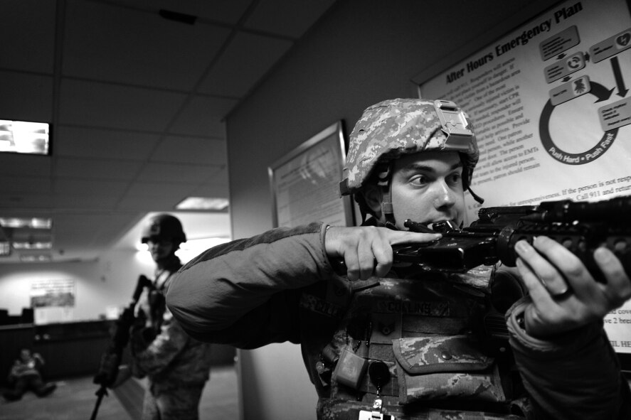 Staff Sgt. Matthew Collins, 50th Security Forces Squadron Response Force Team leader, searches the base fitness center for suspects during Opinicus Vista 18-2 at Schriever Air Force Base, Colorado, Oct. 17, 2018.  Collins and the rest of the response force team cleared the area of a simulated threat during the exercise. (U.S. Air Force Photo by Dennis Rogers)