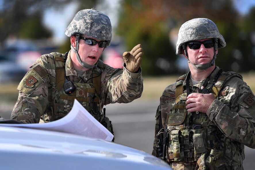 50th Security Forces Squadron patrolmen discuss procedures during the Opinicus Vista 18-2 exercise at Schriever Air Force Base, Colorado, Oct. 17, 2018.  The scenario tested the capabilities of the emergency services agencies and partnering with local community emergency agencies to critical incidents. (U.S. Air Force Photo by Dennis Rogers)