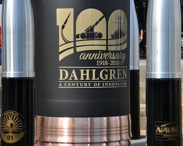 IMAGE: DAHLGREN, Va. (Oct. 19, 2018) – The time capsule at the Naval Surface Warfare Center Dahlgren Division (NSWCDD) centennial grand finale. As participants celebrated Dahlgren’s impact upon the Navy and nation, the time capsule – ten 105 millimeter shells surrounding a 16-inch shell –  was unveiled and all in attendance had the opportunity to write notes and share their thoughts with future generations. Dahlgren personnel can write notes to be placed inside the capsule until the end of 2018 when it will be sealed and opened on Oct. 16, 2068 at the command’s 150th anniversary.