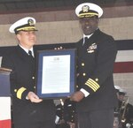 IMAGE: DAHLGREN, Va. (Oct. 19, 2018) – Rear Adm. Tom Anderson, Naval Surface Warfare Center (NSWC) commander, and Capt. Godfrey ‘Gus’ Weekes, NSWC Dahlgren Division commanding officer hold the Virginia General Assembly Resolution proclaiming Oct. 16 as Dahlgren Day during the grand finale celebration of the NSWC Dahlgren Division centennial. Virginia State Sen. Richard Stuart and Virginia Delegate Margaret Ransone read and presented the resolution at the event.