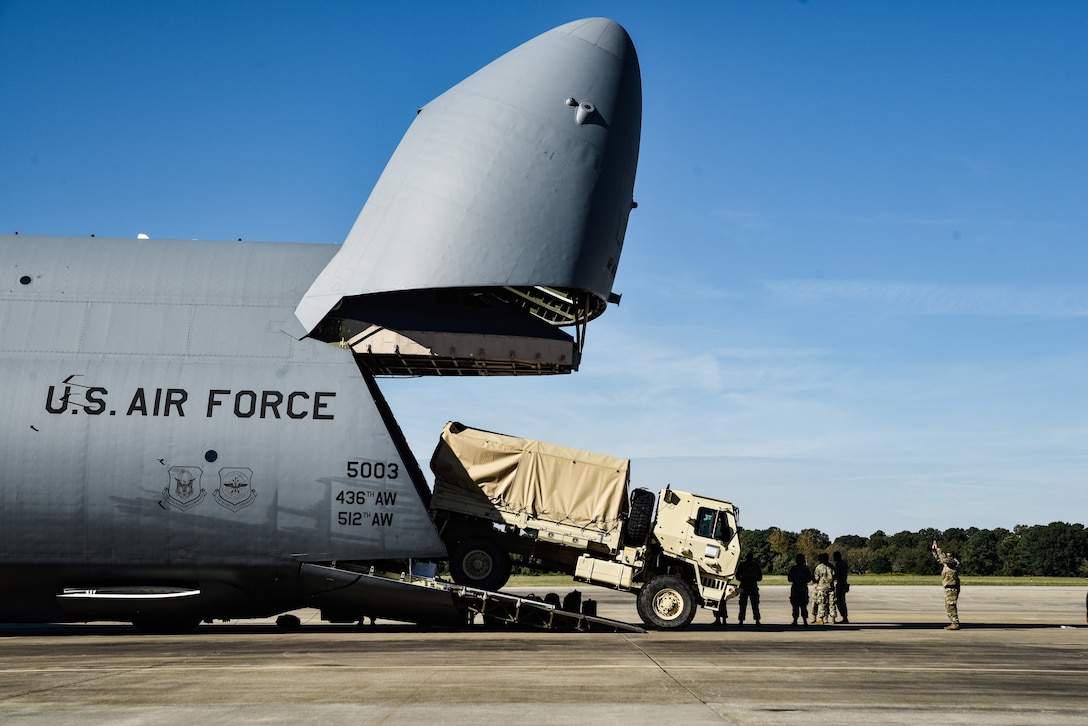 U.S. Army Soldiers from 149th Inland Cargo Transfer Company, 11th Transportation Battalion, 7th Transportation Brigade (Expeditionary), load a LMTV onto a C-5M Super Galaxy from the 9th Airlift Squadron from Dover Air Force Base, Delaware, during a training exercise at Joint Base Langley-Eustis, Virginia, Oct. 19, 2018.