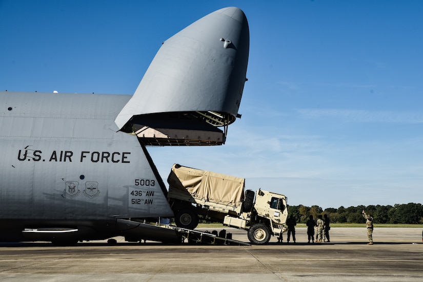 U.S. Army Soldiers from 149th Inland Cargo Transfer Company, 11th Transportation Battalion, 7th Transportation Brigade (Expeditionary), load a LMTV onto a C-5M Super Galaxy from the 9th Airlift Squadron from Dover Air Force Base, Delaware, during a training exercise at Joint Base Langley-Eustis, Virginia, Oct. 19, 2018.