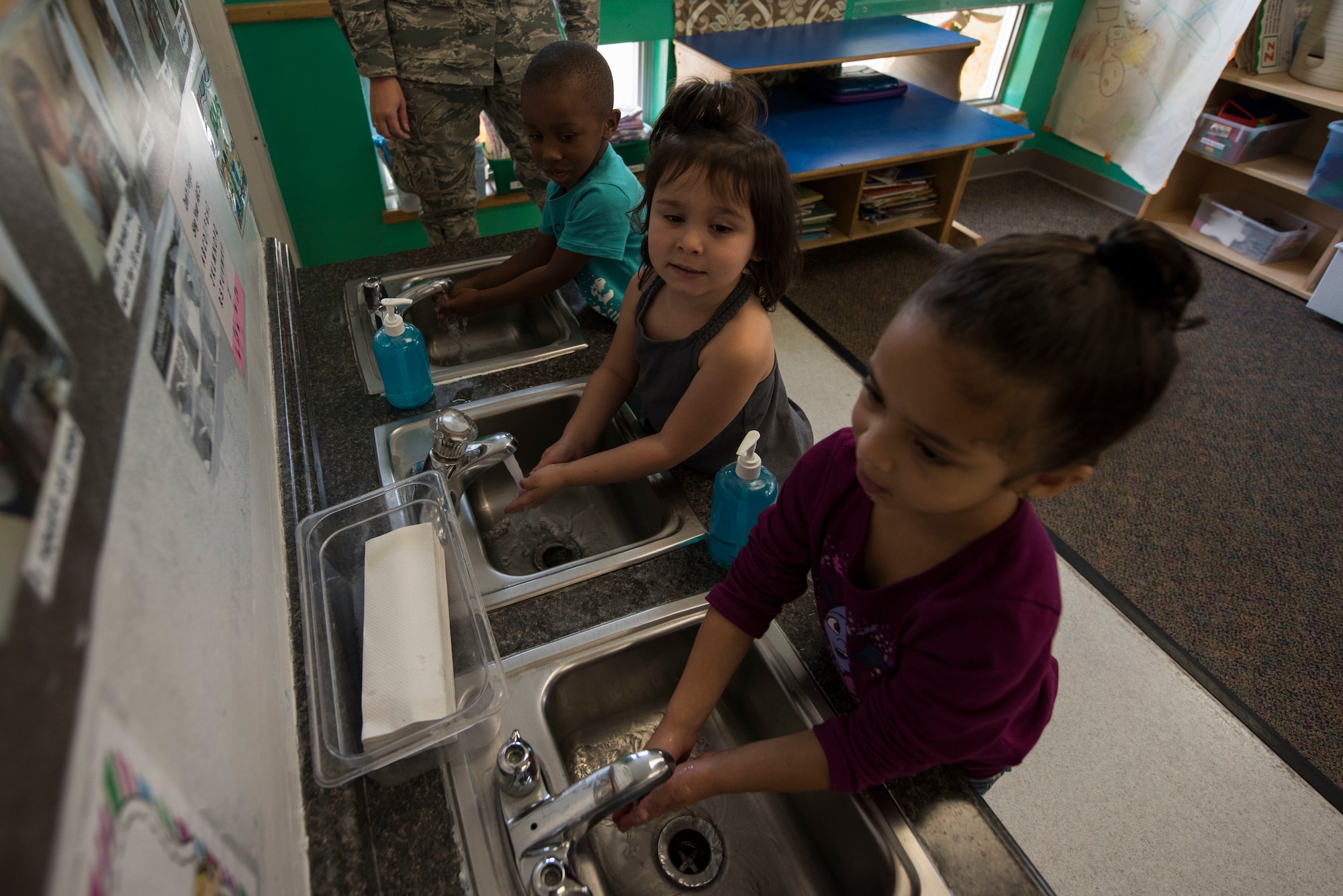 Children wash their hands Oct. 16, 2018, during a hand washing demonstration at the Child Development Center on Dover Air Force Base, Del. The demonstration involved a Glow Germ Classroom Kit that showed children how illnesses spread and how important it is to routinely and thoroughly wash one’s hands. (U.S. Air Force photo by Airman 1st Class Zoe M. Wockenfuss)