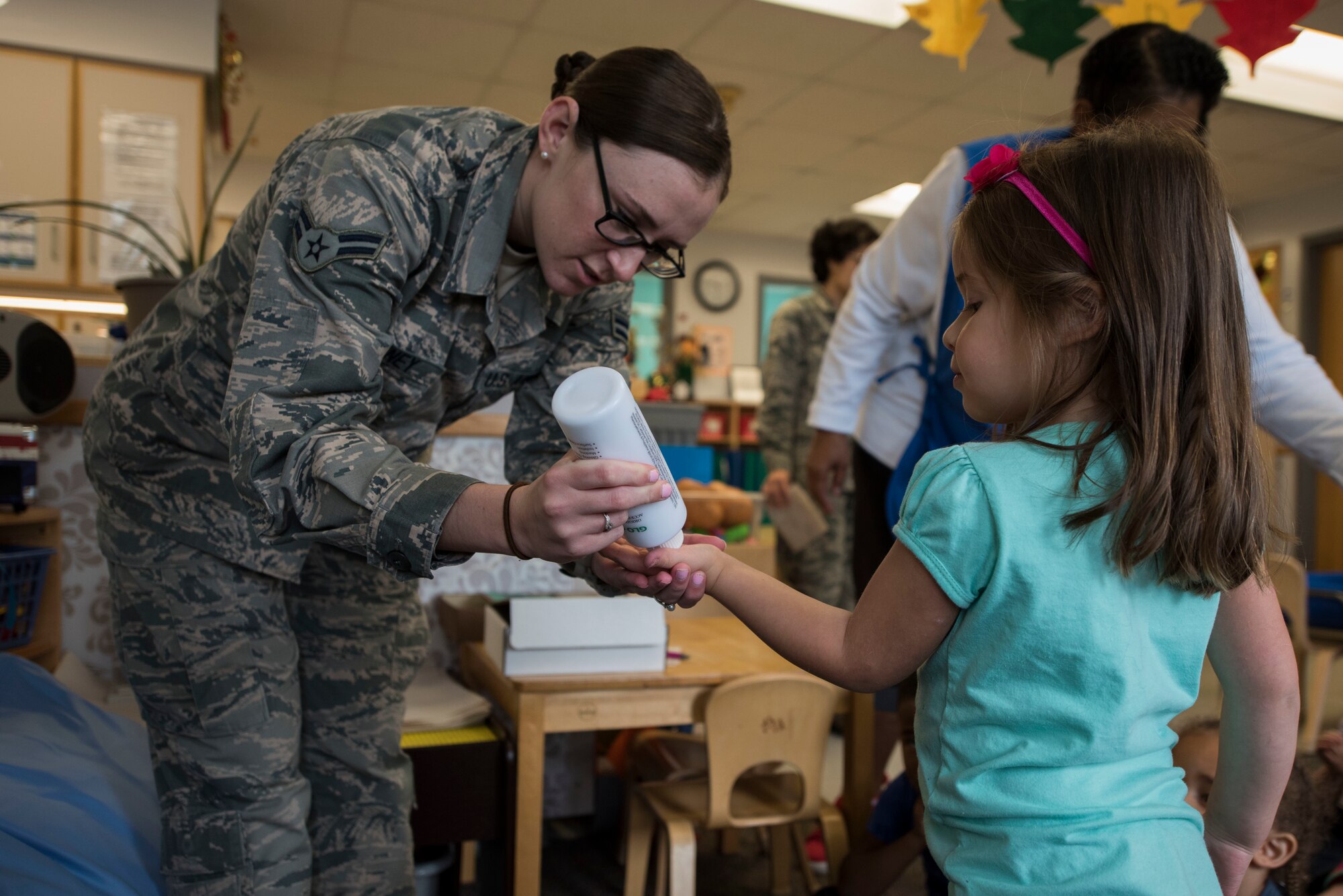 Airman 1st Class Samantha Downey, 436th Aerospace Medicine Squadron public health technician, puts a germ-simulating lotion on the hands of Alessandra Lowry, a student at the Child Development Center, Oct. 16, 2018, during a hand-washing demonstration at the CDC on Dover Air Force Base, Del. The lotion acts as germs on the children’s hands and even after washing some residue may still show up under a black light. (U.S. Air Force photo by Airman 1st Class Zoe M. Wockenfuss)