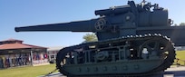 IMAGE: DAHLGREN, Va. (Oct. 19, 2018) –  A restored World War I era gun presides over the Naval Surface Warfare Center Dahlgren Division (NSWCDD) grand finale celebration of the NSWC Dahlgren Division centennial. “The first shot of the new base was fired from a seven-inch, 45-caliber, tractor-mounted gun, just like the one over there,” said Capt. Godfrey ‘Gus’ Weekes, NSWCDD commanding officer, while pointing to the century-old gun on display. Since that shot was fired on Oct. 16, 1918, Dahlgren scientists and engineers rose to the occasion time and again to provide the Navy with innovative solutions based on their technical capability to integrate sensors, weapons, and associated weapon and combat systems into surface ships and vehicles.