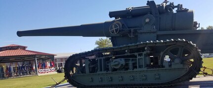 IMAGE: DAHLGREN, Va. (Oct. 19, 2018) –  A restored World War I era gun presides over the Naval Surface Warfare Center Dahlgren Division (NSWCDD) grand finale celebration of the NSWC Dahlgren Division centennial. “The first shot of the new base was fired from a seven-inch, 45-caliber, tractor-mounted gun, just like the one over there,” said Capt. Godfrey ‘Gus’ Weekes, NSWCDD commanding officer, while pointing to the century-old gun on display. Since that shot was fired on Oct. 16, 1918, Dahlgren scientists and engineers rose to the occasion time and again to provide the Navy with innovative solutions based on their technical capability to integrate sensors, weapons, and associated weapon and combat systems into surface ships and vehicles.