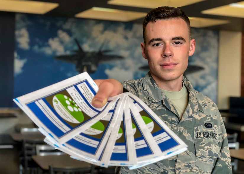 U.S. Air Force Airman 1st Class Graham Cunliffe-Owen, 633rd Air Base Wing cybersecurity technician, hands out pamphlets promoting good cybersecurity techniques for National Cyber Security Awareness month at the Joint Base Langley-Eustis, Virginia, Oct. 10, 2018.