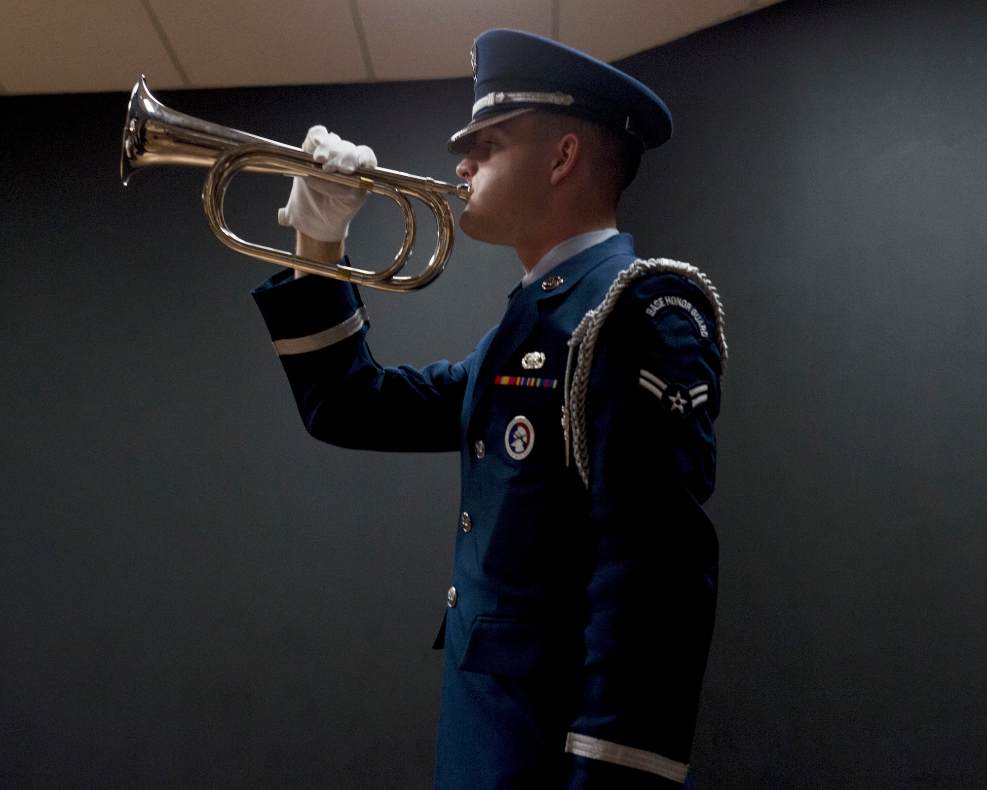 U.S. Air Force Airman 1st Class William Douglass, member of the Altus Blue Knights Honor Guard team, plays taps on the bugle, Oct. 19, 2018, at Altus Air Force Base, Okla.