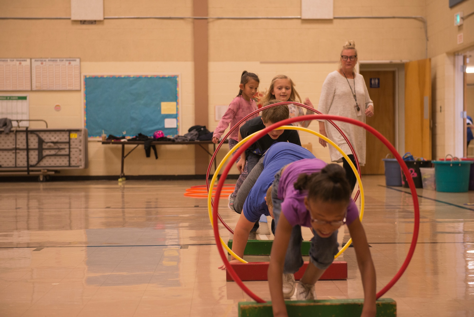 Airmen from the 366th Fighter Wing help students complete an obstacle course at North Elementary School, in Mountain Home, Idaho, October 4, 2018. North Elementary hosted their annual "Move-A-Thon" as a fundraiser for the students to go on field trips. (U.S. Air Force photo by Senior Airman Tyrell Hall)